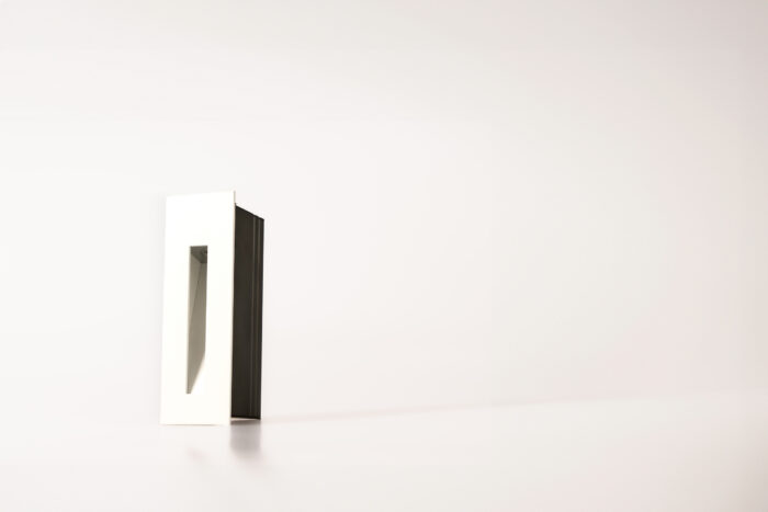 Matt white rectangle low-level recessed step light for ground washing with a black installation sleeve
