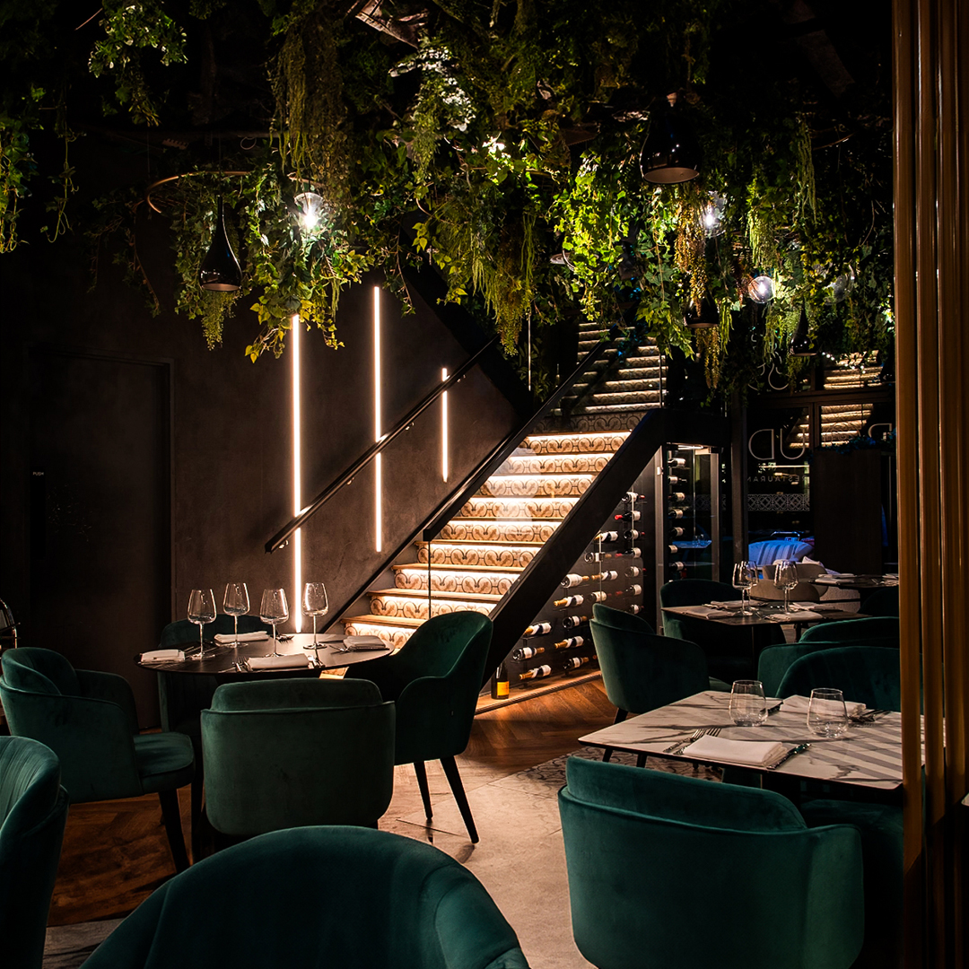 Modern London restaurant Boudica with green and black interior design with LED linear lighting and spotlights