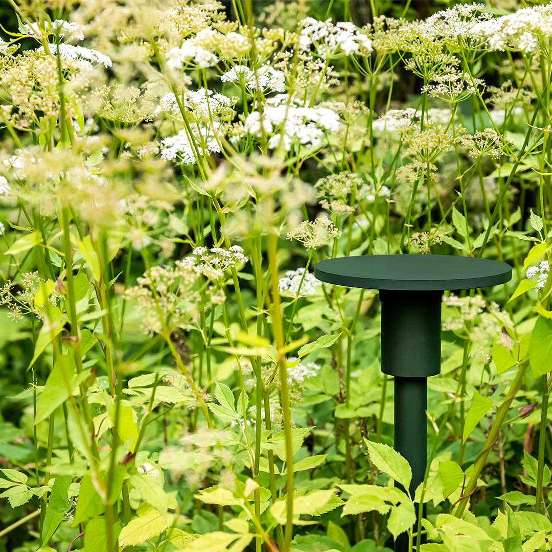 Exterior spike light with flat top to cast light downwards ceramic coated dark green to blend in with foliage