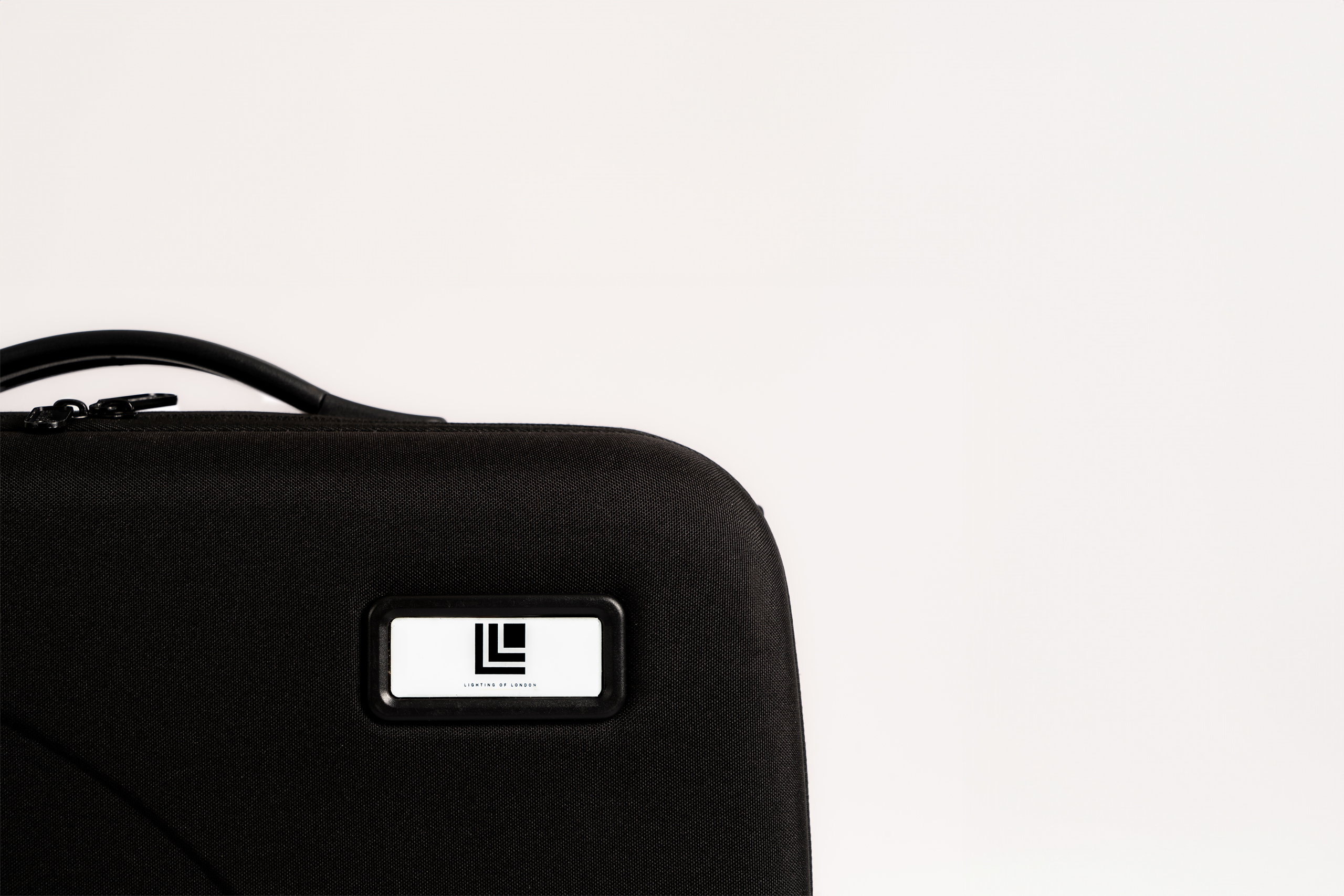 Black hard-backed demonstration case / sample kit with company logo