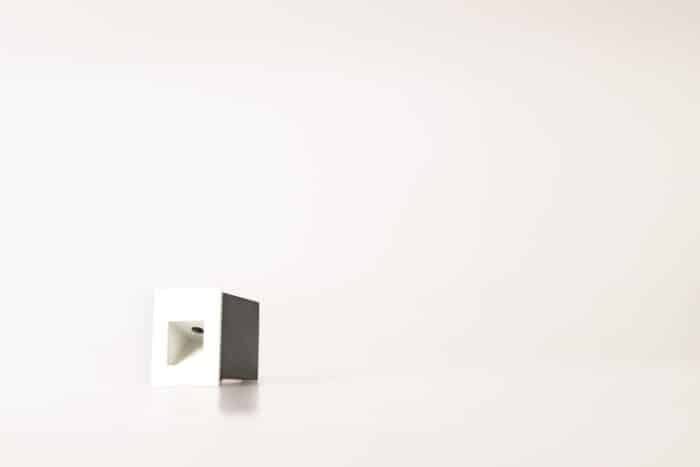 Matt white square low-level recessed step light for ground washing with a black installation sleeve