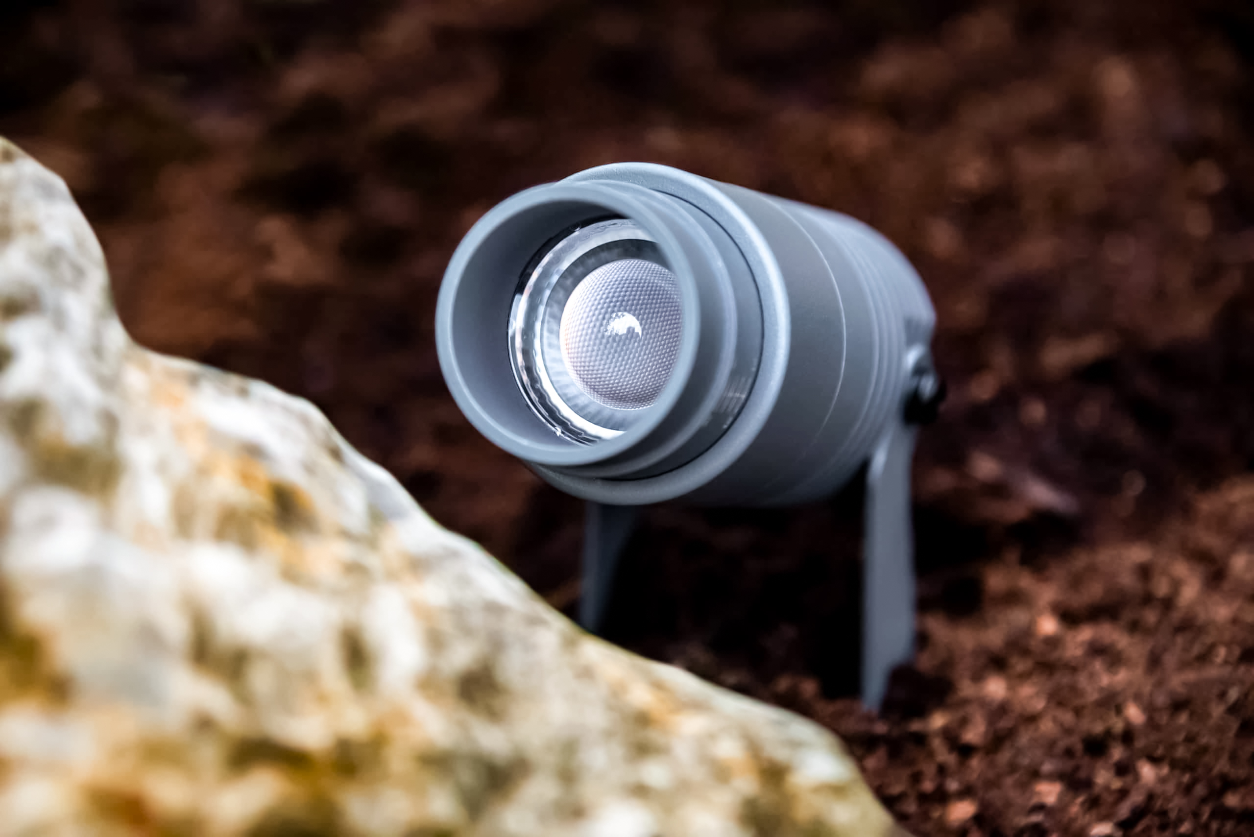 exterior spotlight with zoom function in flower bed